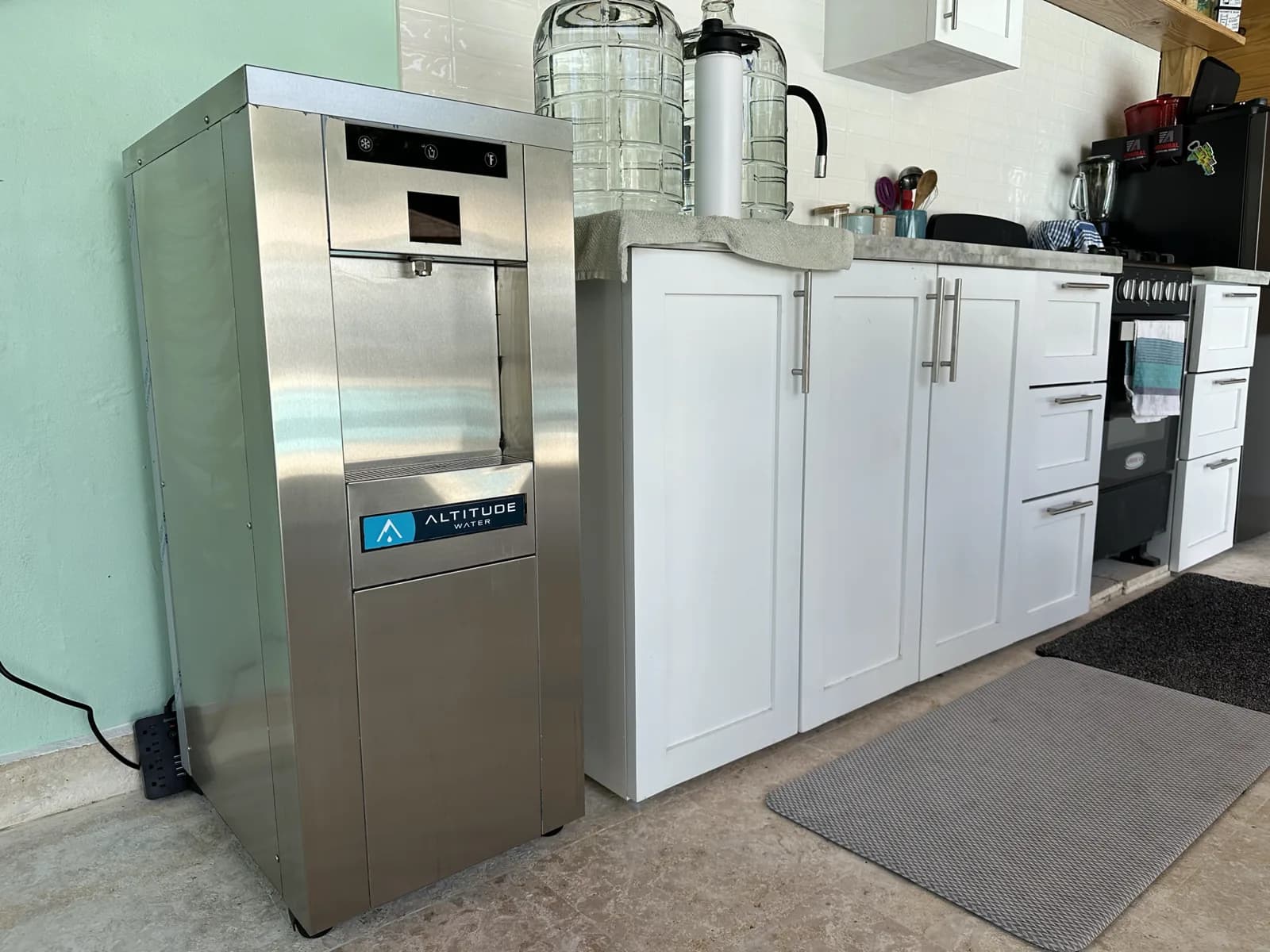 T-12 next to a white cabinet with empty 5-gallon bottles on top.